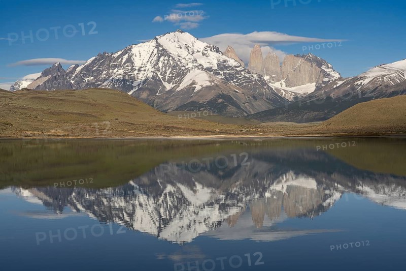 Torres del Paine granite towers with snow-covered mountain range, reflection in Amarga lagoon, steppe in the foreground, Torres del Paine National Park, Patagonia, Chile