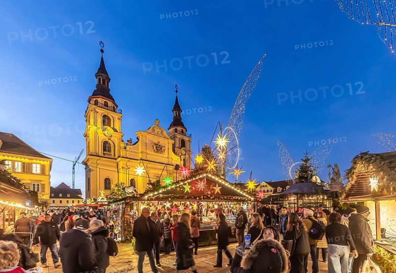 Baroque Christmas market with illuminated angels between the Protestant City Church and the Catholic Church of the Most Holy Trinity. Sights on the market square in the evening. Ludwigsburg, Baden-Württemberg, Germany