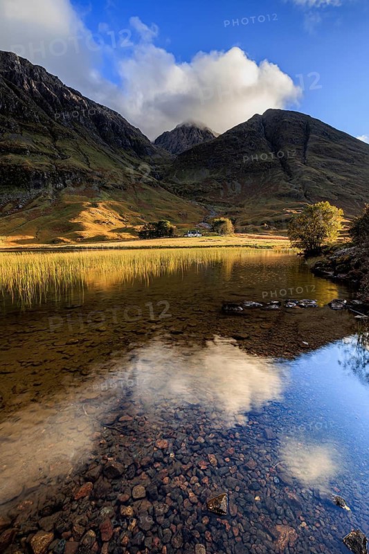 Mountains reflected in loch, evening light, cloudy mood, Achnambeithach Cottage, Loch Achtriochtan, Glencoe, Scottish Highlands, Scotland, Great Britain