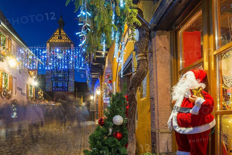 Colour-illuminated and Christmassy decorated half-timbered houses, blue hour, Christmas market, Riquewihr, Grand Est, Haut-Rhin, Alsace, France