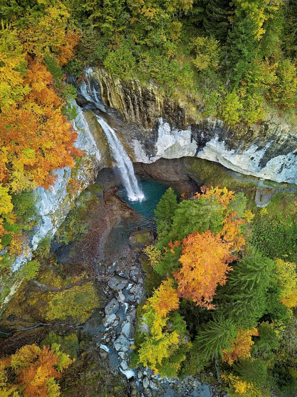 Aerial view of Berglistüber waterfall in autumn-colored surroundings, Linthal, Klausenpass, Canton of Glarus, Switzerland