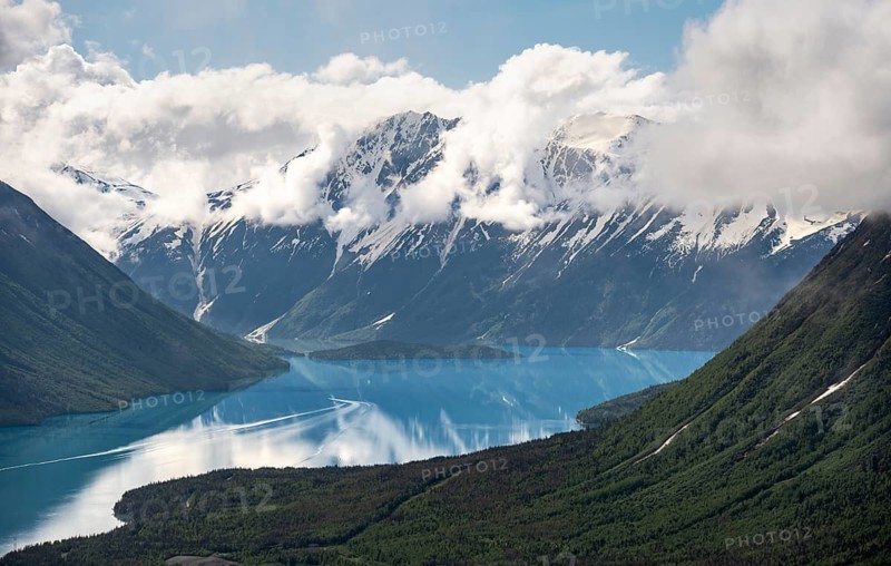 View of snowy mountains in spring and turquoise Kenai Lake with reflection, Slaughter Ridge Trail, Cooper Landing, Kenai Peninsula, Alaska, USA
