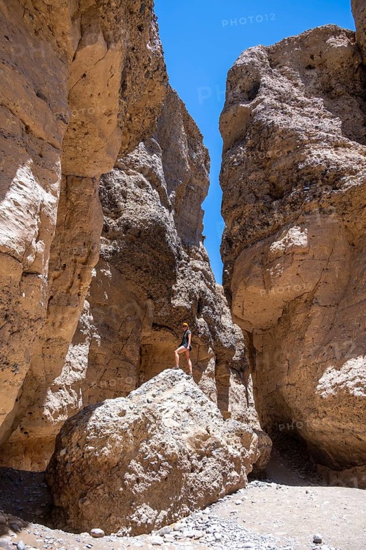 Tourist on a rock, Sesriem Canyon, Namib-Naukluft Park, Namibia