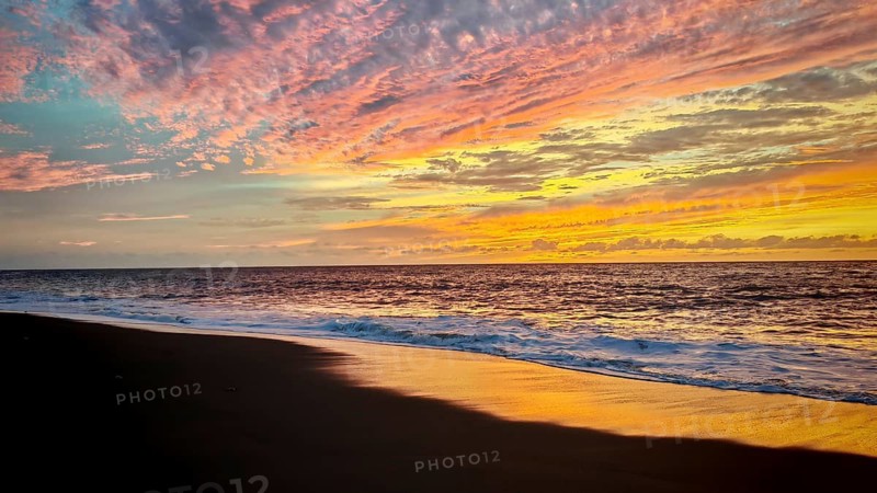 Play of colors in the sky during sunset at the sea with soft waves, romantic, Tarrafal de Monte Trigo, Santo Antao, Cabo Verde, Cape Verde, Cape Verde