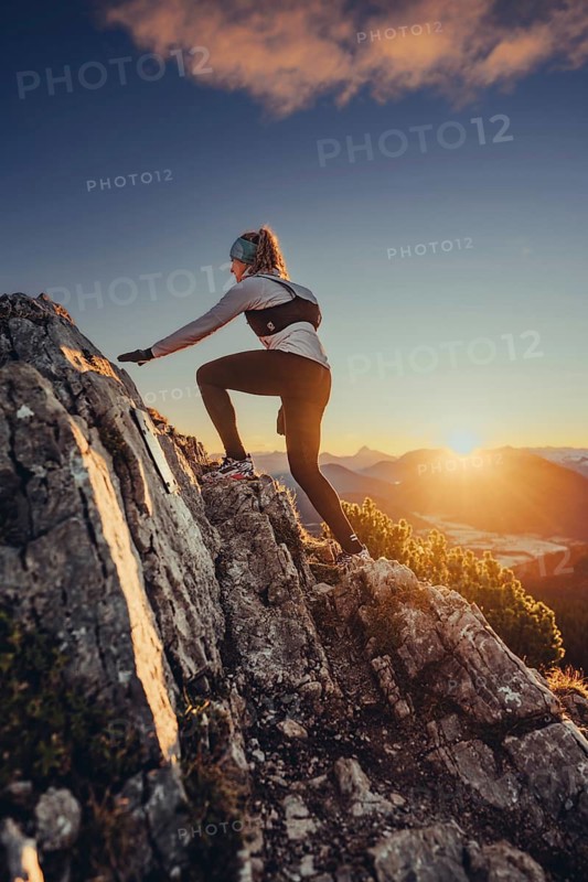 Trail running in autumn on the Jochberg on Lake Walchensee against the wonderful backdrop of the Alps, Bavaria, Germany