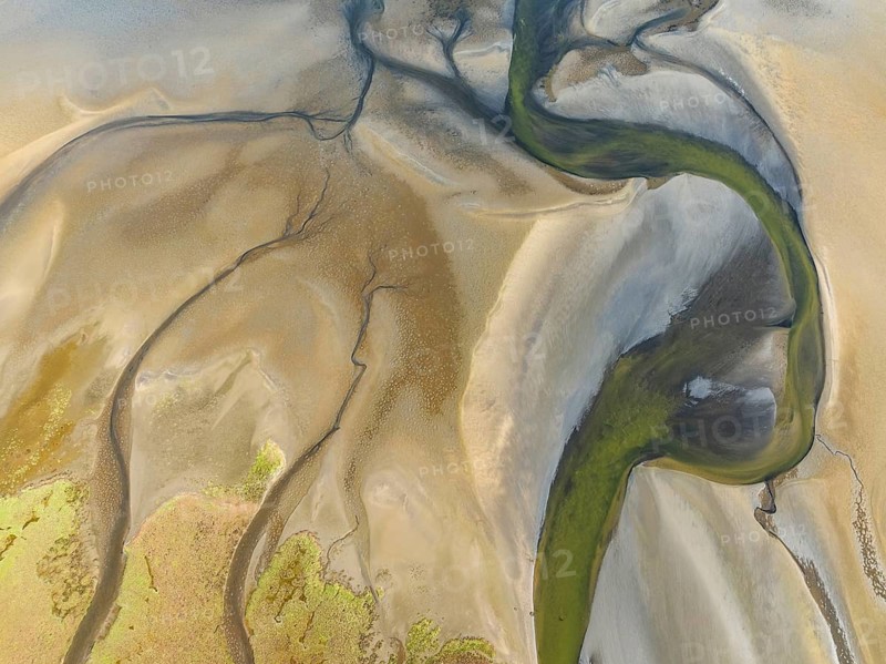 Streams and marshes at low tide in the wetlands of the Walvis Bay lagoon. Aerial view. Drone shot. Walvis Bay, Namibia