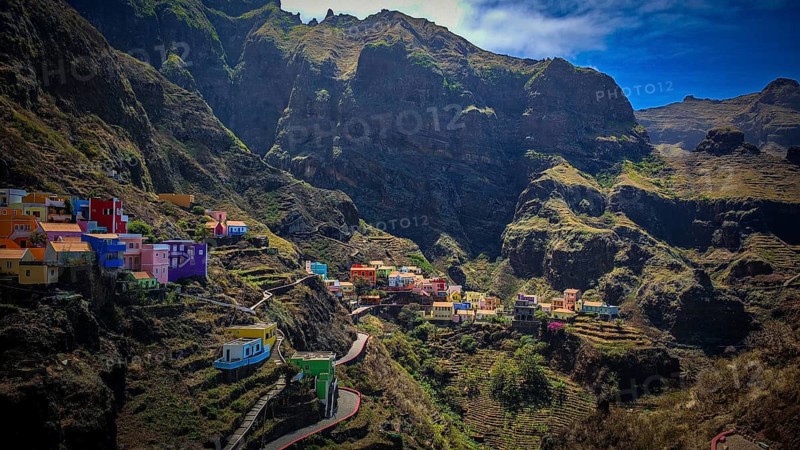 Panoramic view, small settlement, colorful village, nestled in raw, dramatic mountains under blue skies, spectacular hiking, natural heritage, cultural heritage, terraces in Fontainhas, Santo Antao, Cabo Verde, Cape Verde, Cape Verde, Cape Verde