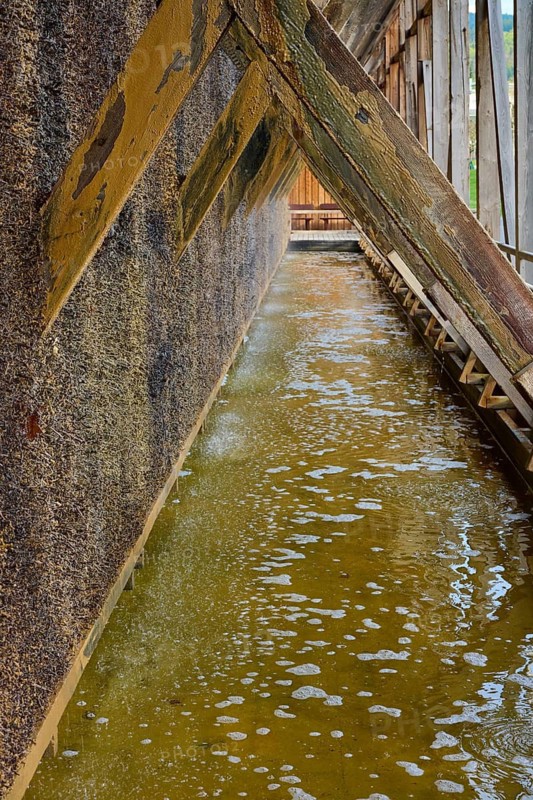 Detailed view of a graduation house with foamy water under wooden beams, spa town of Bad Orb, Spessart nature park Park, Main Kinzig district, Hesse, Germany