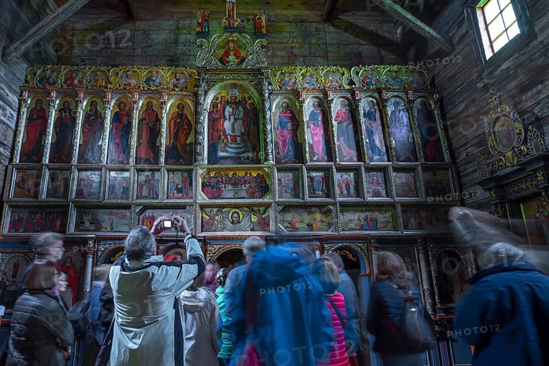 Orthodox chancel painted with iconostases, 16th century Gothic wooden church of St. Paraskevi, with a tour group in front, Radruz, Poland