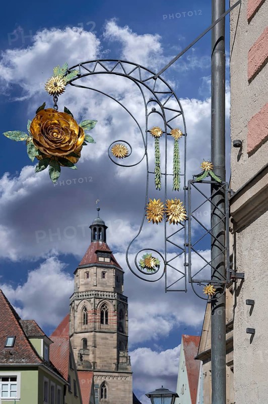 Nose sign of the Hotel Rose, 18th century, Rosenstraße 6, behind the tower of the parish church of St Andrew, Weißenburg, Middle Franconia, Bavaria, Germany