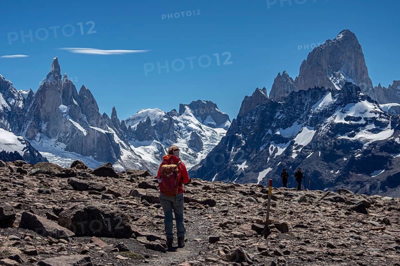HIking woman, trail to viewpoint Loma del Pliegue Tumbado, mountain range of Cerro Torre and Cerro Fitz Roy in the back, El Chalten, Argentina