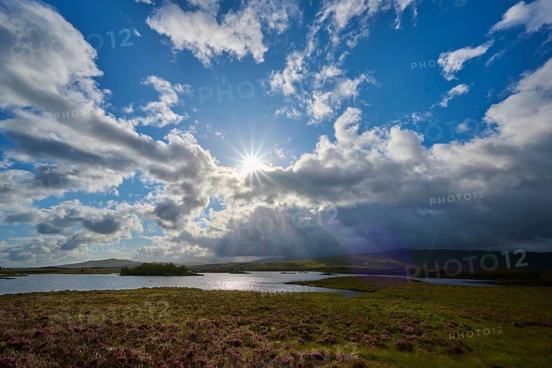 Wide natural landscape with sunbeams through clouds, river and green meadow, Rannoch Moor, Bridge of Orchy, Scotland, United Kingdom, Great Britain