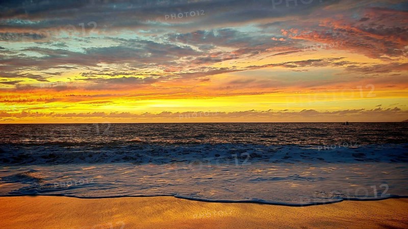 Romantic, golden, colorful sunset over the sea with soft waves and golden horizon, Tarrafal de Monte Trigo, Santo Antao, Cabo Verde, Cape Verde, Cape Verde