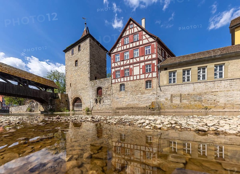 Sulfer Tower. Historic ensemble of buildings. Paved ford across a stove arm from the river island of Grasbödele in the foreground to Haalplatz behind the tower. City view of Schwäbisch Hall. Schwäbisch Hall, Baden-Württemberg, Germany