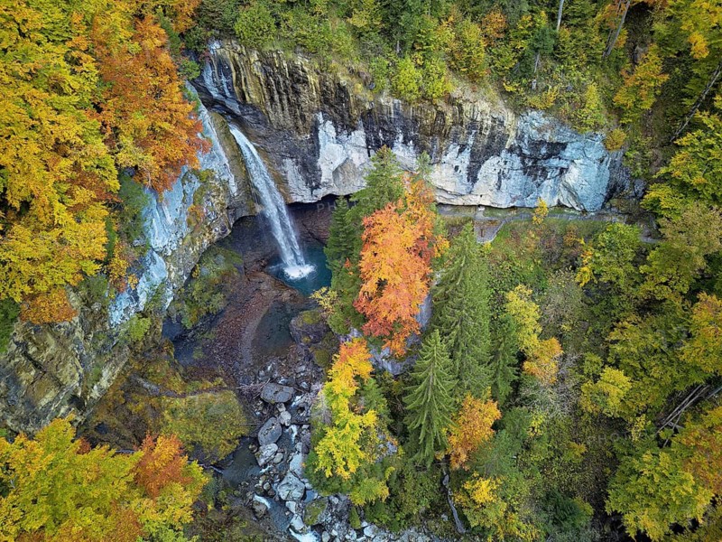 Aerial view of Berglistüber waterfall in autumn-colored surroundings, Linthal, Klausenpass, Canton of Glarus, Switzerland