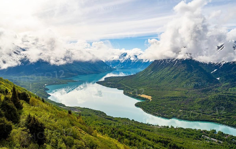 View of snowy mountains in spring and turquoise blue Kenai Lake, Slaughter Ridge Trail, Cooper Landing, Kenai Peninsula, Alaska, USA