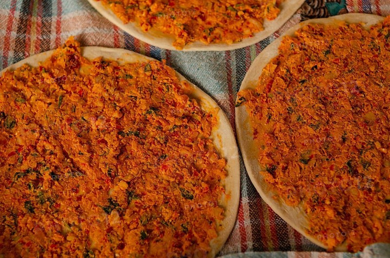 Traditional Turkish Biberli Ekmek Flat bread with red pepper paste being prepared before cooking in Antakya Hatay, Turkey