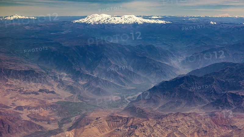 Extensive mountain landscape with snow-capped peaks and deep valleys, the landscape and desert near Nasca in the Andes of Peru