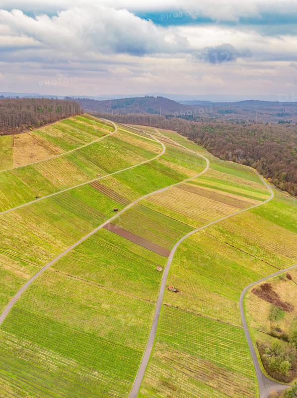 Winding hills and fields seen from the air, under an overcast sky, Großbottwar, Ludwigsburg district, Baden-Württemberg, Germany