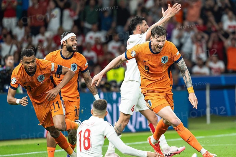 BERLIN, GERMANY - JULY 6, 2024: Euro 2024 quarterfinal match Nederlands vs Turkey (Turkiye) 2:1. Cody Gakpo (L) Memphis Depay and Wout Weghorst (R) joy after scoring goal.