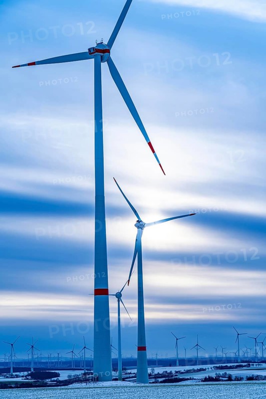 Wind farm, north of Lichtenau, self-proclaimed energy town, over 190 wind turbines and over 1200 solar panels generate 10 times as much electricity as the community of 11, 900 inhabitants consumes, largest onshore cluster of wind turbines in Germany, winter, slightly snow-covered landscape, North Rhine-Westphalia, Germany