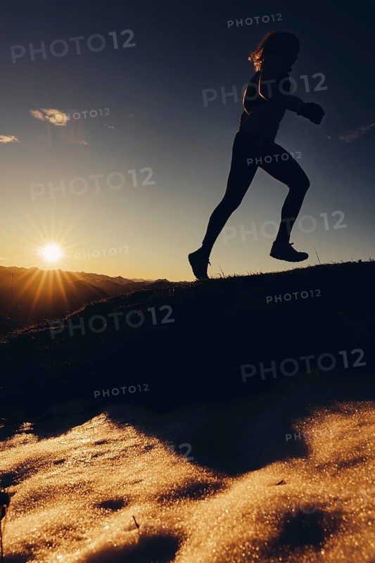 Trail running in autumn on the Jochberg on Lake Walchensee against the wonderful backdrop of the Alps, Bavaria, Germany