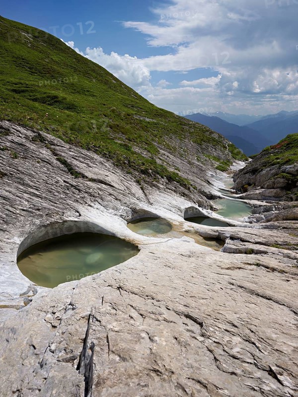 Glacier mill with glacier pots on the Trinser Alp Mora, Trin, Canton Graubünden, Switzerland