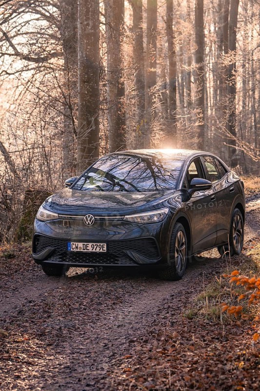 Car driving through a shady forest path in sunlight, Car Sharing, electric car, Volkswagen ID 5, Gechingen, Hecken und Gäu Region, Black Forest, Germany