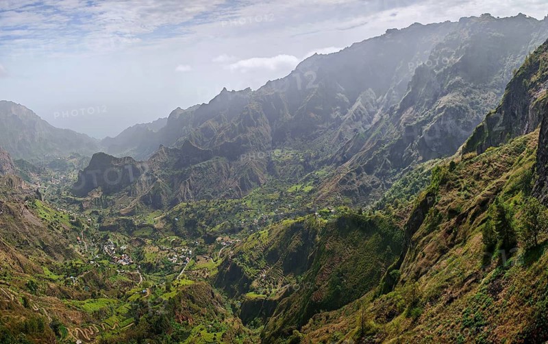 Panorama, panoramic view, lush green valley in the midst of a majestic mountain landscape under cloudy sky, hiking from Cova Crater through Paul Valley, Ribeira do Paul to Vila das Pombas, Santo Antao, Cabo Verde, Cape Verde, Cape Verde