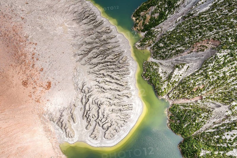 Lake with sandbank and dead trees, crater rim of chaiten volcano, aerial view, Patagonia, Chile