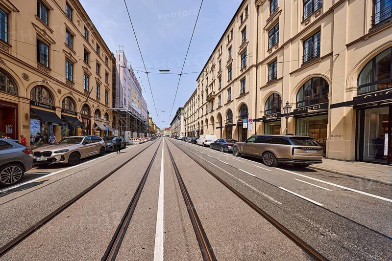 Luxury shops, historic residential and commercial buildings, general architecture, street, center line, tram tracks, overhead lines, parking strips with vehicles, milky blue sky, cirrostratus clouds, Maximilianstraße, Munich, state capital, district-free city, Bavaria, Germany