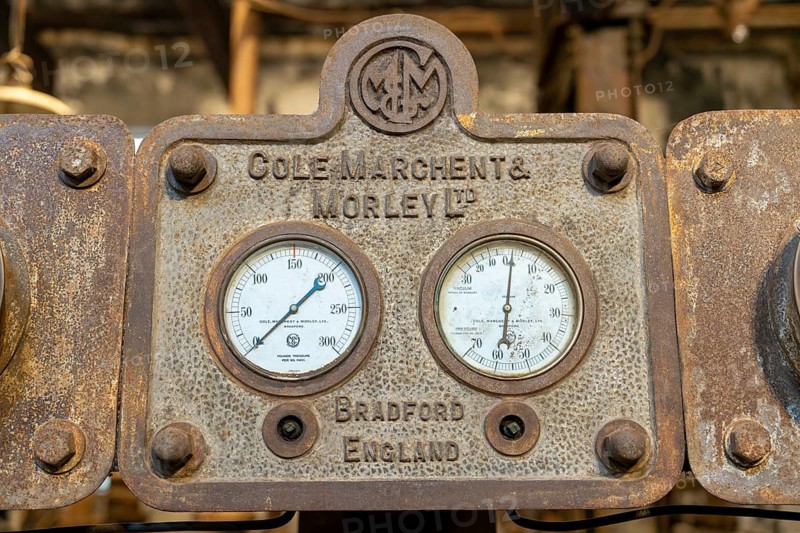 Historic pressure and vacuum pressure gauges on a cast iron steam engine from the manufacturer Cole, Marchent & Morley Ltd. from Bradford, England, with rust patina and company embossing, Frigorífico Anglo, Fray Bentos, Uruguay