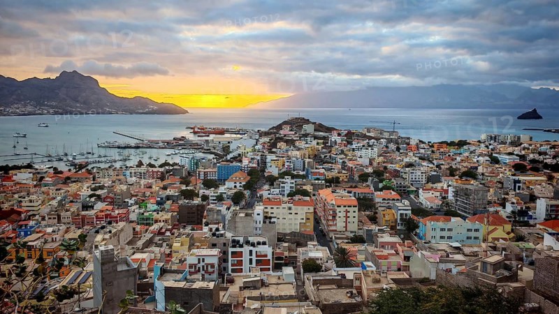 Panoramic view from above of coastal town of Mindelo at sunset with colorful buildings, harbor and mountains, Mindelo, Sao Vicente, Cabo Verde, Cape Verde, Cape Verde