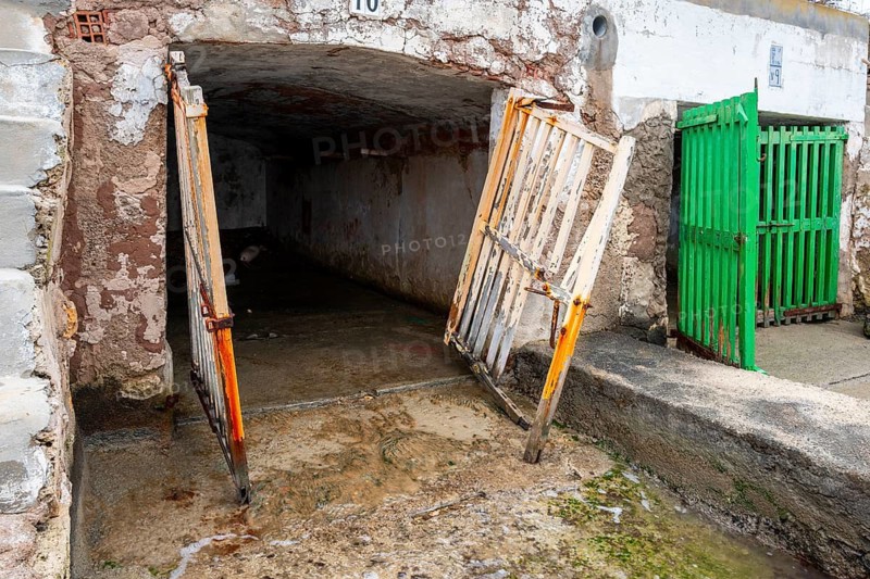 Old and dilapidated boat shelters that are not being used, old port area in Portocolom on the east coast of Majorca, Spain