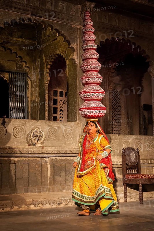 UDAIPUR, INDIA, NOVEMBER 24: Bhavai performance, famous folk dance of Rajasthan state of India. Performer balances number of earthen pots as she dance. November 24, 2012 in Udaipur, Rajasthan, India