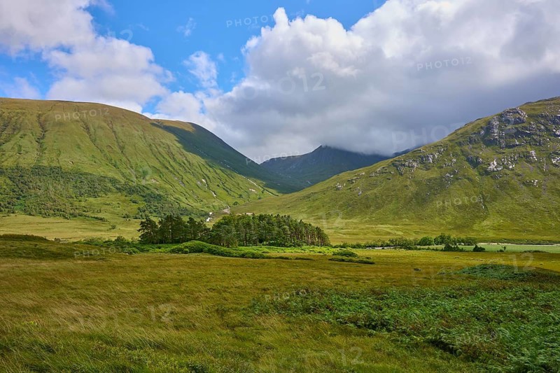 Green valleys and mountains under a partly cloudy blue sky surrounded by meadows, Loch Etive, Argyll and Bute, Scotland, United Kingdom, United Kingdom