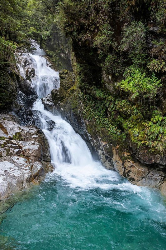 Waterfall with rocks, Christie Falls, Falls Creek, Fiordland National Park, Southland Region, South Island, New Zealand