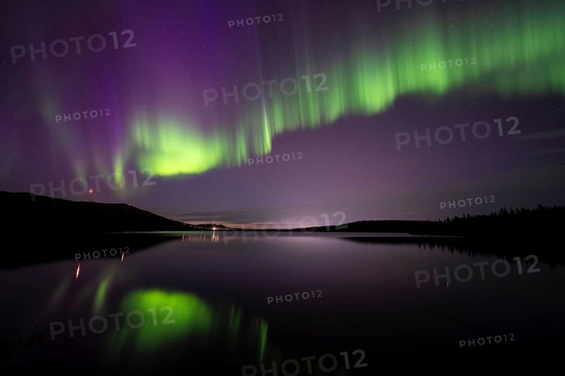 Northern Lights (Aurora borealis) reflected in a forest lake, Gällivare, Norrbotten, Lapland, Sweden, September 2023