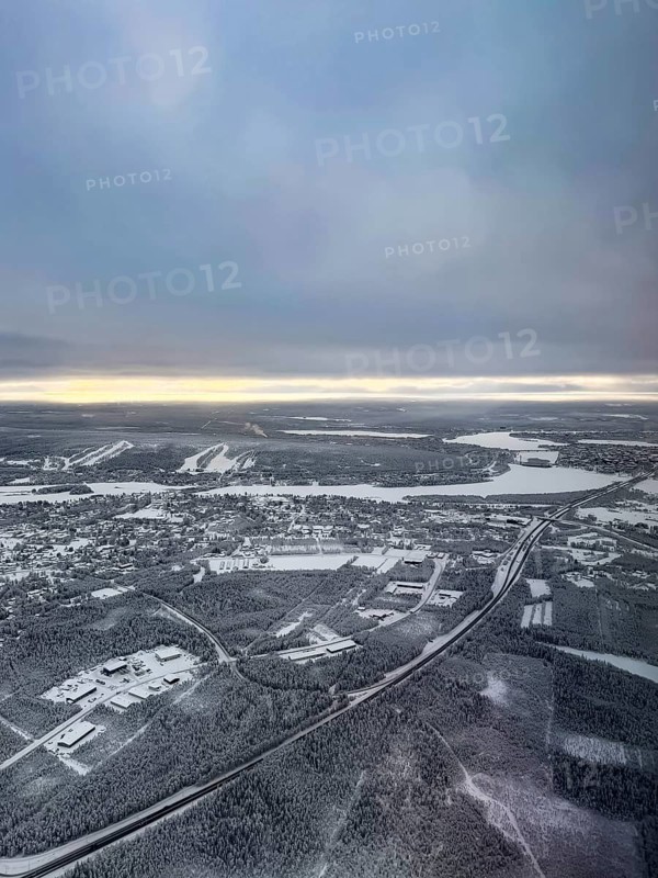 View of the snowy town of Rovaniemi with the Kemijoki river, in winter, aerial view, Finland