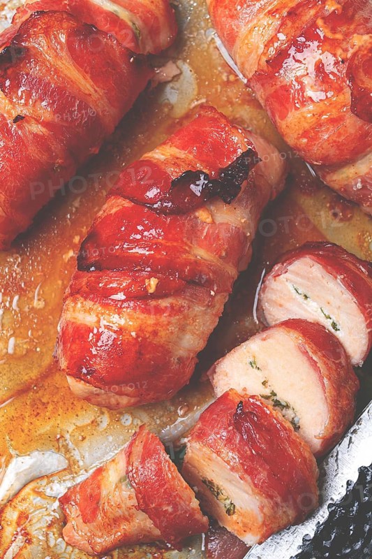 Baked chicken breast, wrapped in bacon, on a baking tray. in the home kitchen.close-up