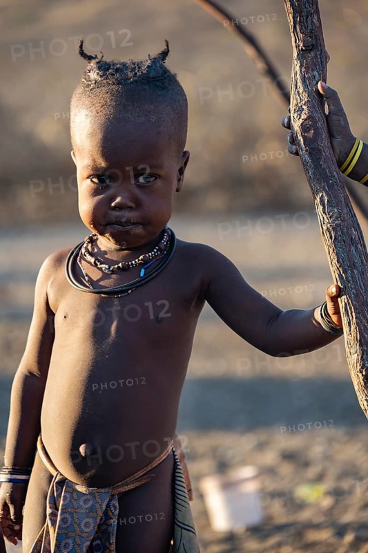 Himba child, in the morning light, traditional Himba village, Kaokoveld, Kunene, Namibia