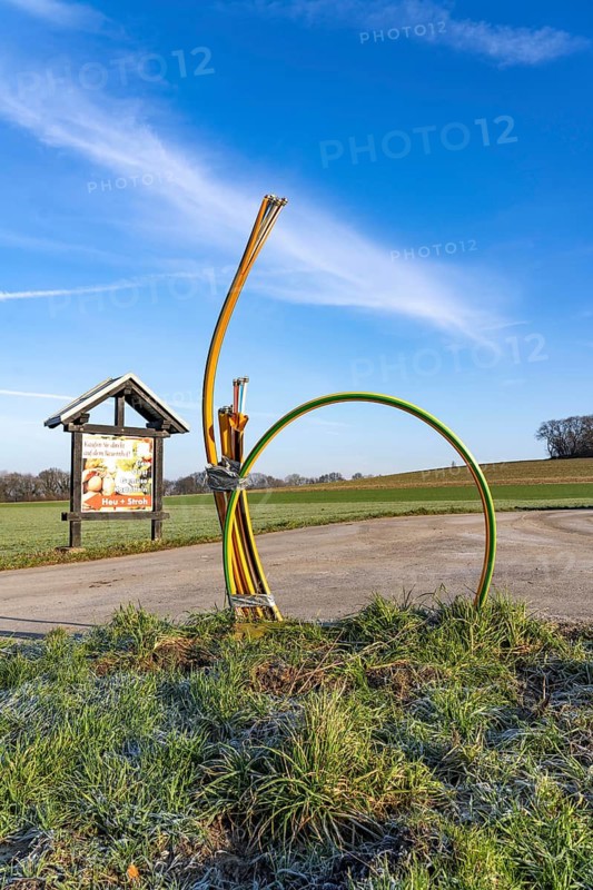 Fibre optic connection, empty conduits protrude from the ground along a dirt track, into which the actual fibre optic cable is later blown and connected to the respective house connection or distributor, provision of fast Internet in rural areas, in the south of Mülheim an der Ruhr, North Rhine-Westphalia, Germany