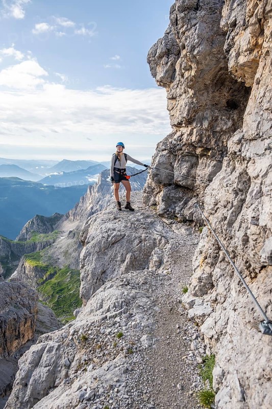 Climbers on a rock band, Bocchette Centrale band trail, via ferrata in the Brenta Mountains, Brenta-Adamello Natural Park, Trentino, Italy