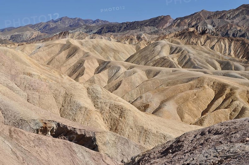 Eroded hills in the desert under clear blue sky, Zabriskie Point, Death Valley National Park, Mojave Desert, California, Nevada, USA