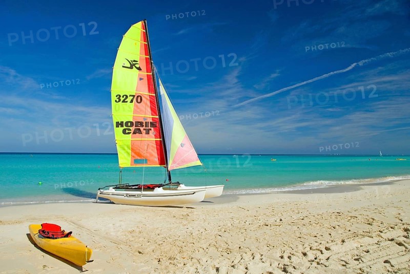 Cuba, Caribbean, Varadero, catamaran on the beach, tourism, sailing, water sports, yellow sail, blue sky Varadero