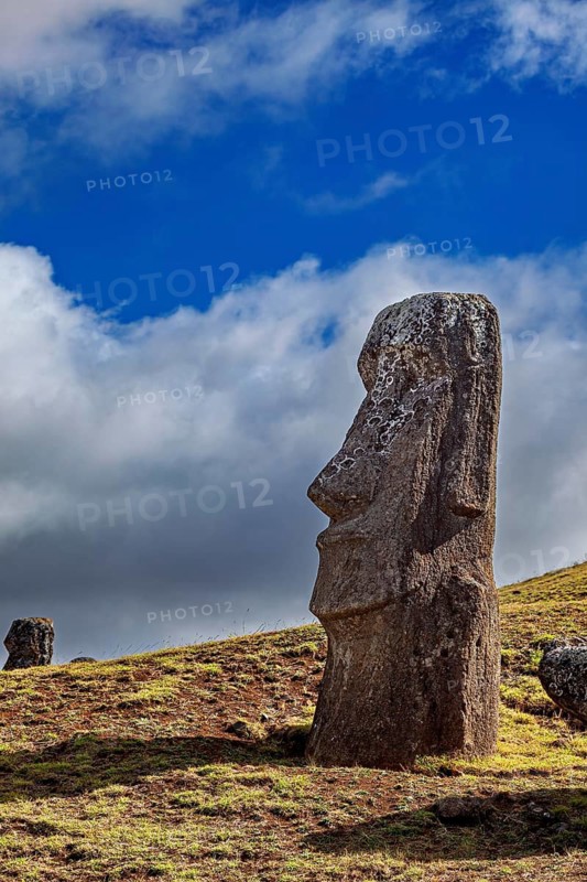 A single moai against a blue sky with clouds on Easter Island, The moai statues on Easter Island in the Pacific Ocean