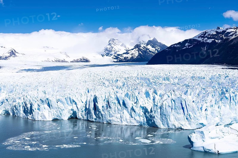 Perito Moreno glacier, glacier breakaway with ice towers and blue crevasses, Lake Argentino with ice floes in the foreground, snow-capped Andes in the background, Los Glaciares National Park, Santa Cruz Province, Patagonia, Argentina