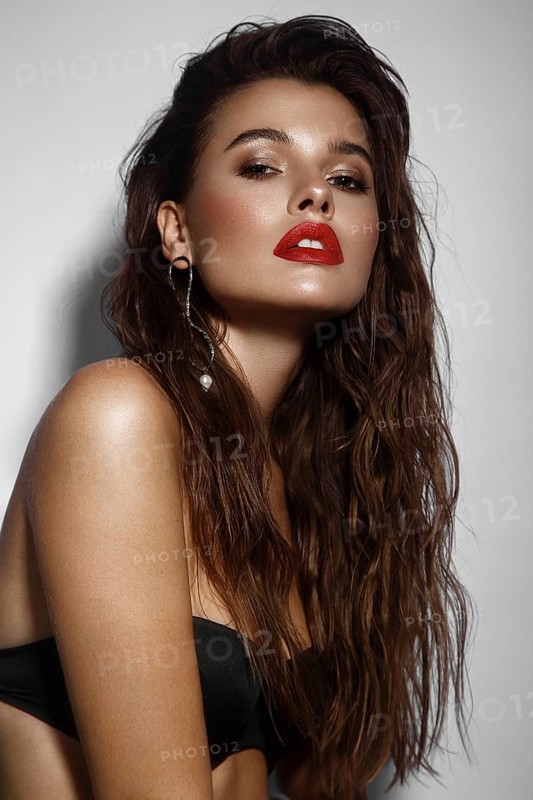 Beautiful sexy girl with bright makeup, red lips, wet hair. Beauty face. Photo taken in studio