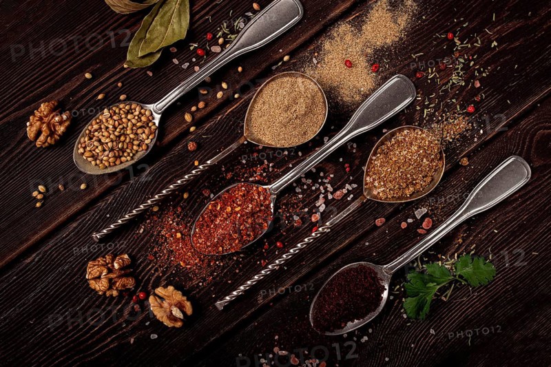 Georgian spices in spoons, on a wooden background, top view, no people