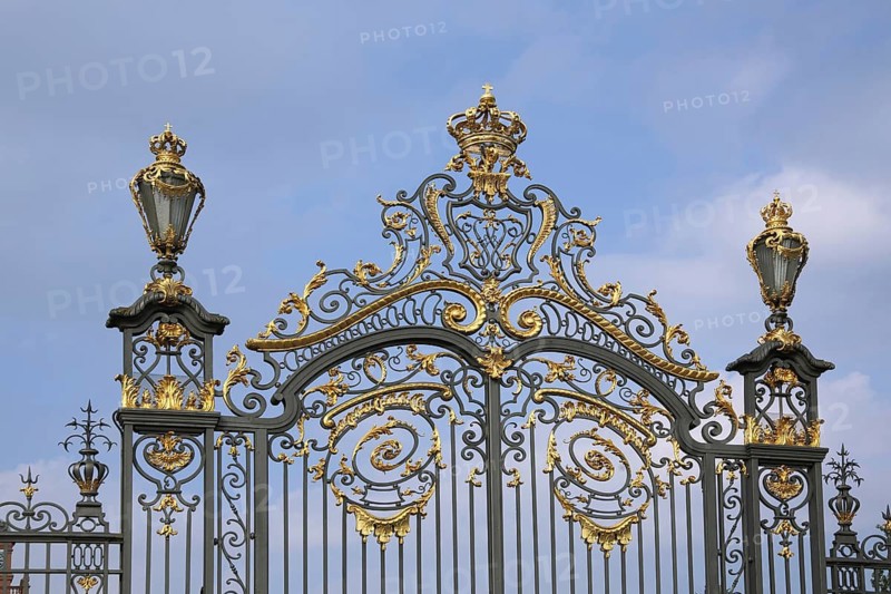 Magnificent golden metal gate with crown and lanterns, decorations, metal bars, ironwork, detail, cutout, baroque Philippsruhe Palace, Kesselstadt, Hanau, Hesse, Germany